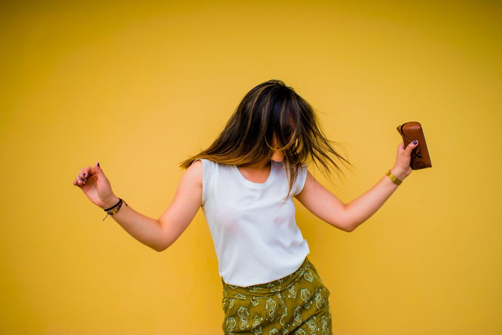 dancing girl against yellow background