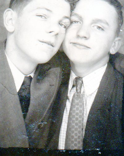 Black and white photo of 2 young men from the 1910's. Both wearing a coat and tie.