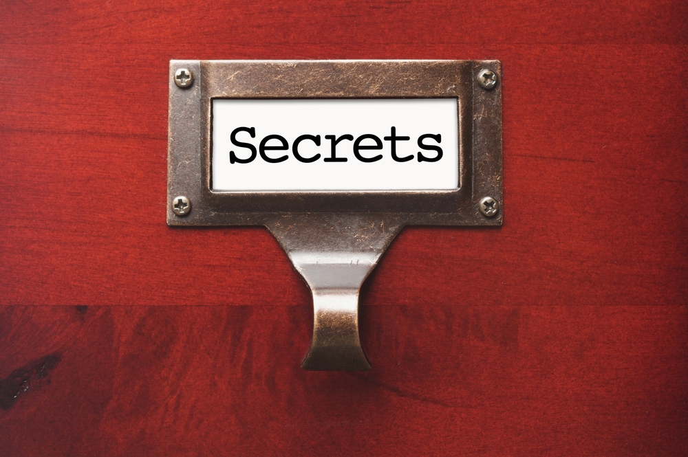 Lustrous Wooden Cabinet with Secrets File Label in Dramatic LIght.