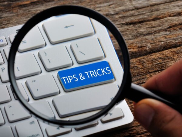 Magnifying glass over blue computer key reading tips and tricks
