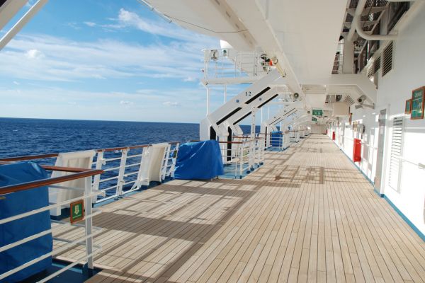 Boardwalk on a cruise ship with ocean on the left