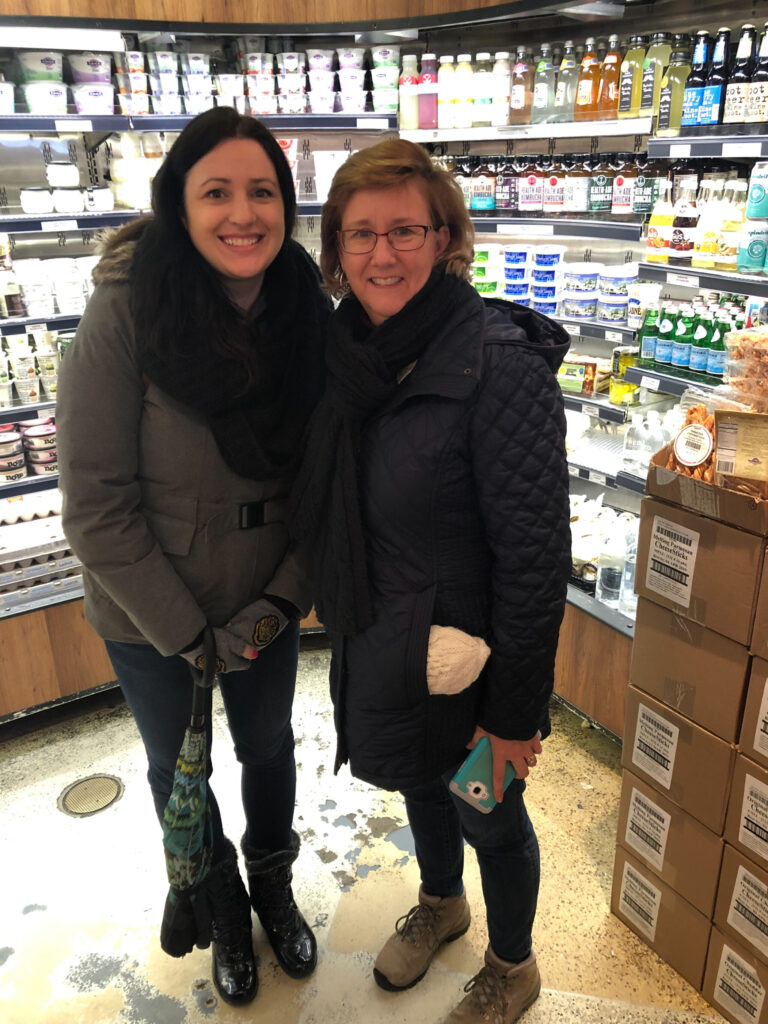 Ashley Covelli and Lisa Lisson smiling in the market