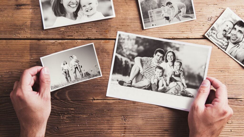 Hands holding old family photos