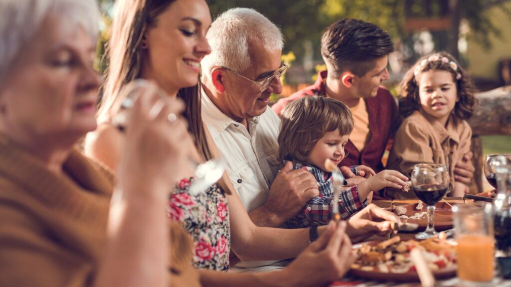 Multi generational family eating together