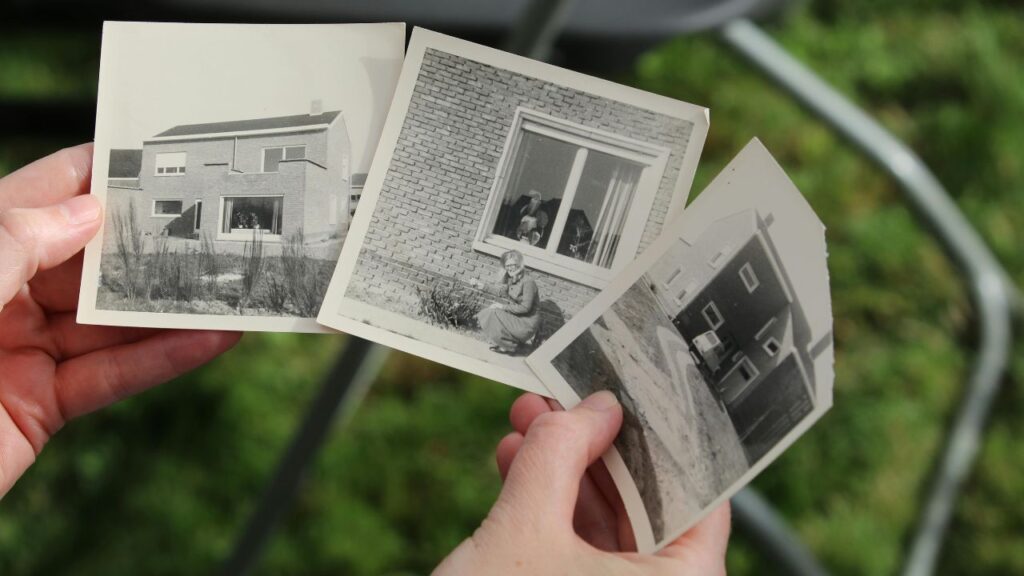 Hands holding three black and white photos