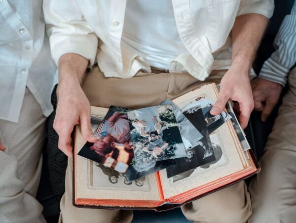 Family of three looking at old family photos