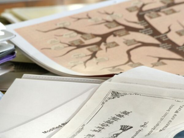Genealogy research workspace showing old documents